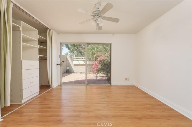 empty room featuring ceiling fan and light hardwood / wood-style flooring