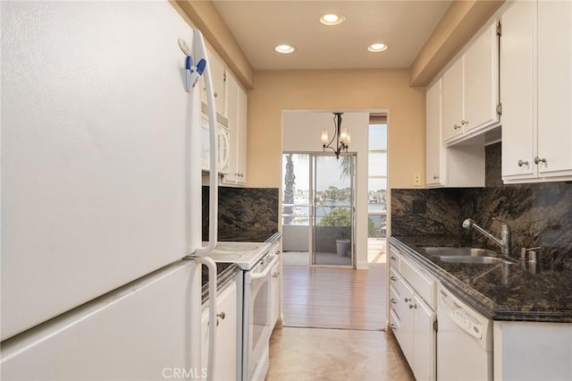 kitchen with sink, pendant lighting, white appliances, decorative backsplash, and white cabinets