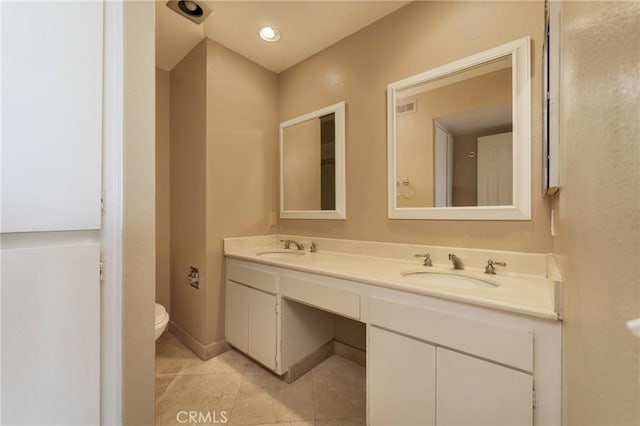 bathroom with tile patterned flooring, vanity, and toilet