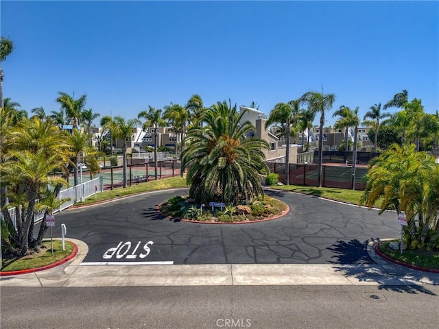 view of home's community with tennis court