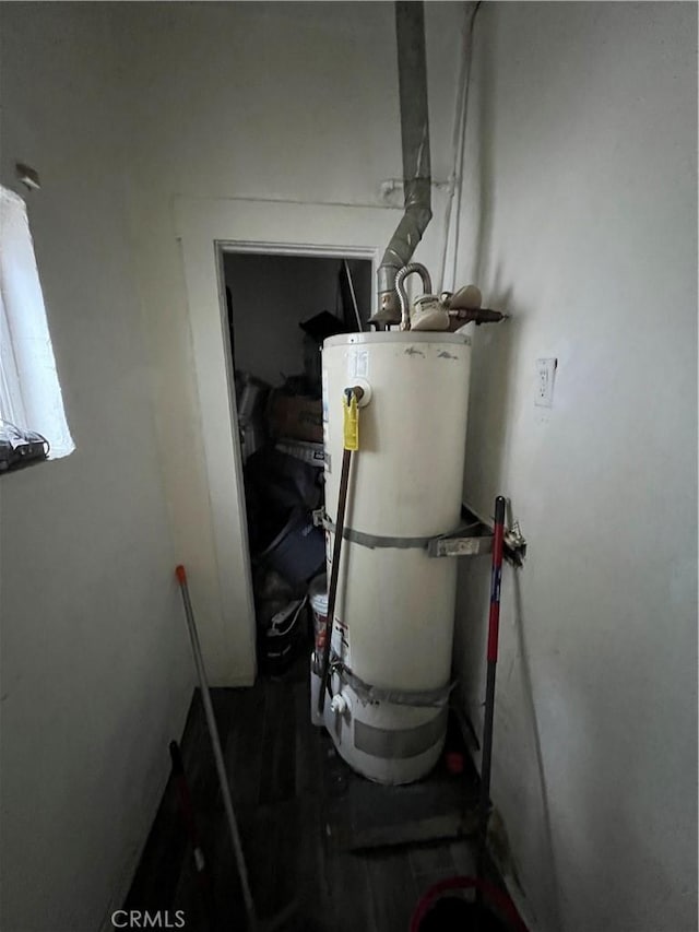 utility room with strapped water heater