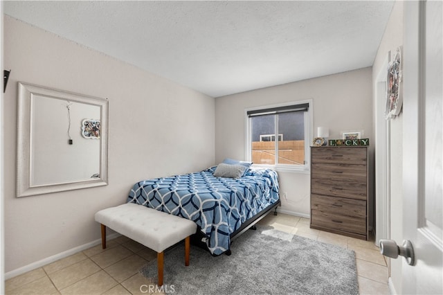 tiled bedroom with a textured ceiling