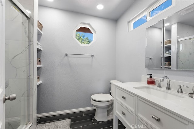 bathroom featuring vanity, walk in shower, and toilet