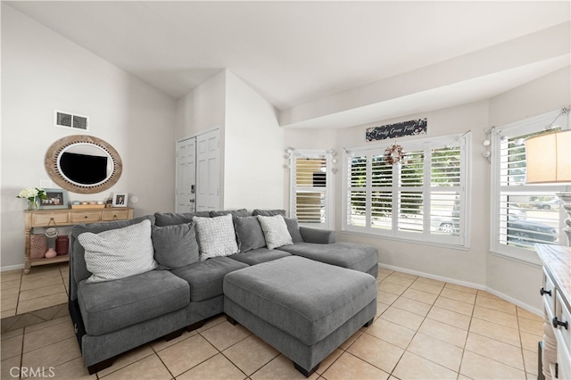 living room with lofted ceiling and light tile patterned flooring