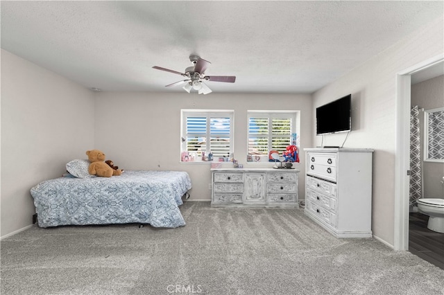 bedroom with connected bathroom, ceiling fan, light carpet, and a textured ceiling