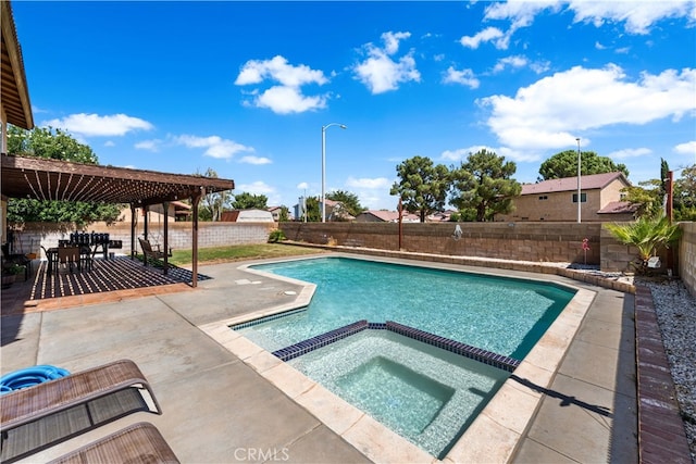 view of swimming pool with an in ground hot tub and a patio