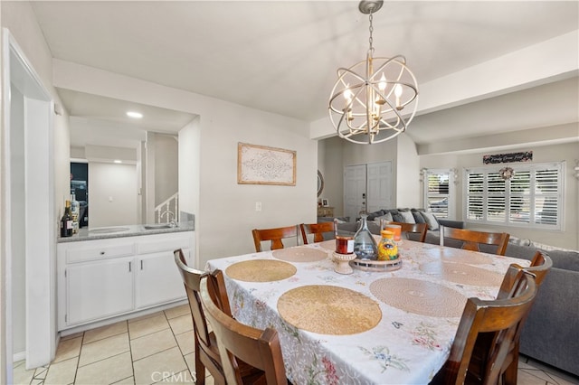 tiled dining space featuring sink and an inviting chandelier