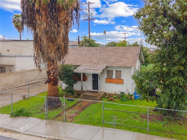 bungalow-style home with a front lawn