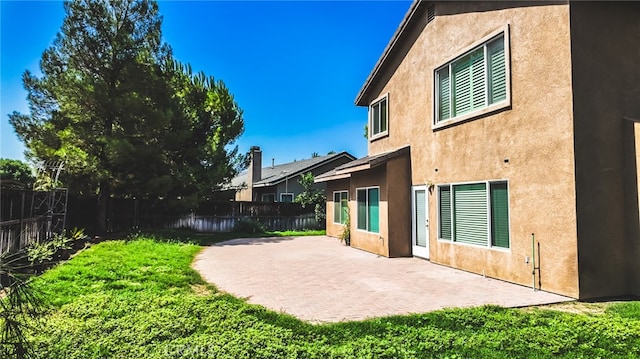 rear view of property featuring a patio area