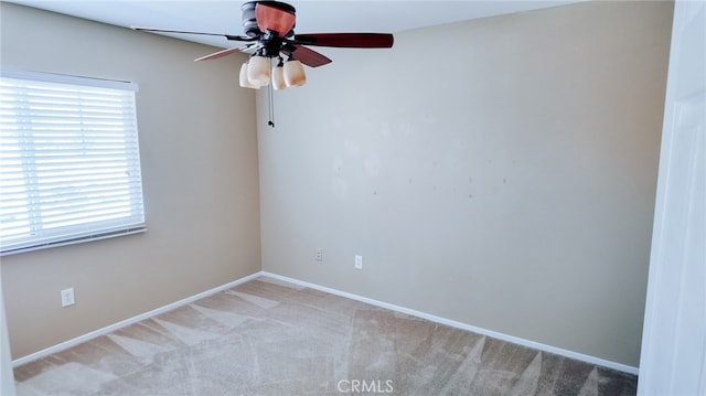 empty room with ceiling fan and light carpet