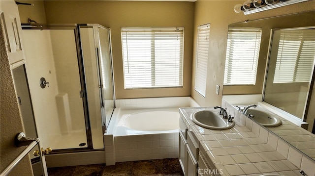 bathroom with independent shower and bath, vanity, and plenty of natural light