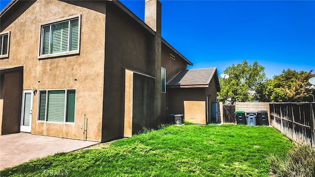 back of house with a patio, a yard, and cooling unit