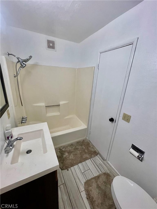 full bathroom with vanity, shower / bath combination, and toilet