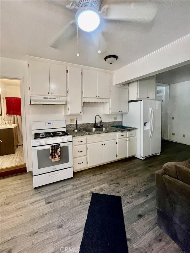 kitchen featuring white cabinets, white appliances, light hardwood / wood-style floors, and sink