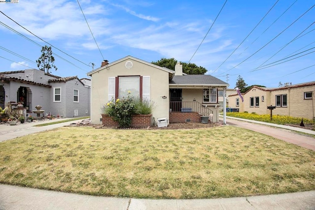 bungalow-style home with a porch and a front yard