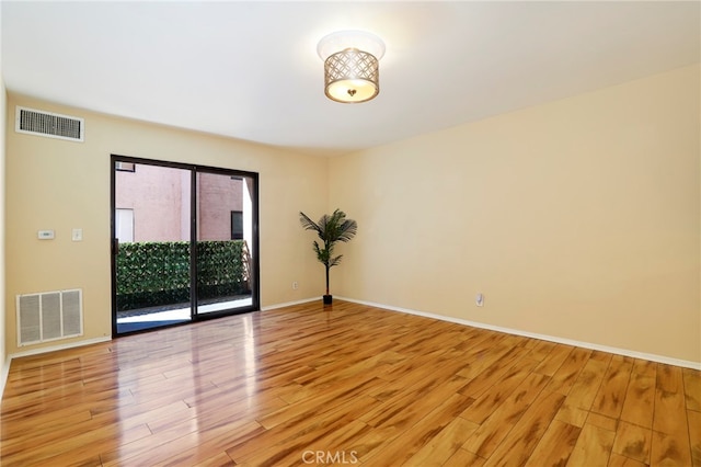 spare room featuring light hardwood / wood-style flooring