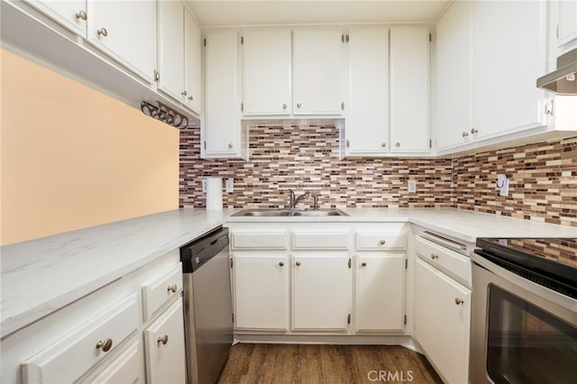 kitchen featuring sink, white cabinets, decorative backsplash, stainless steel appliances, and dark hardwood / wood-style flooring