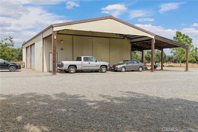 view of parking / parking lot featuring a carport and a garage