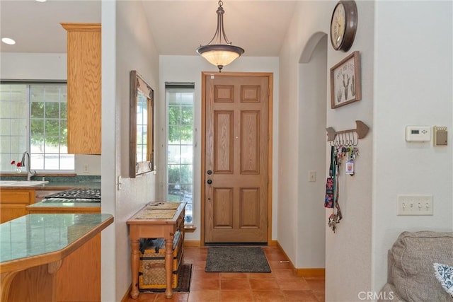 tiled foyer entrance featuring sink