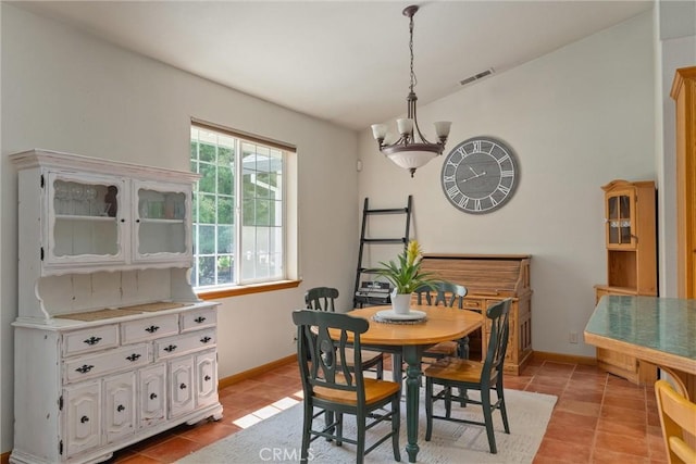 dining room featuring light tile patterned floors and a chandelier