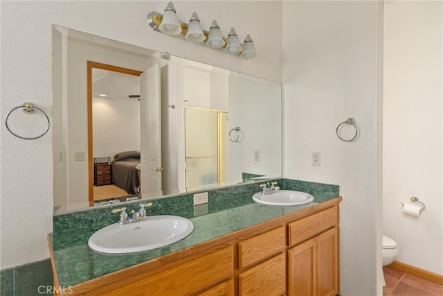 bathroom with tile patterned floors, vanity, and toilet