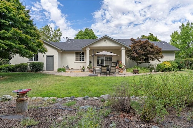 view of front facade with a patio and a front yard