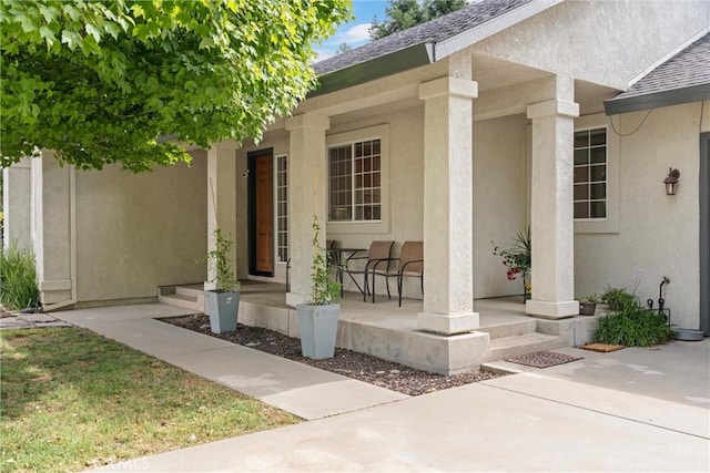 view of exterior entry with a porch