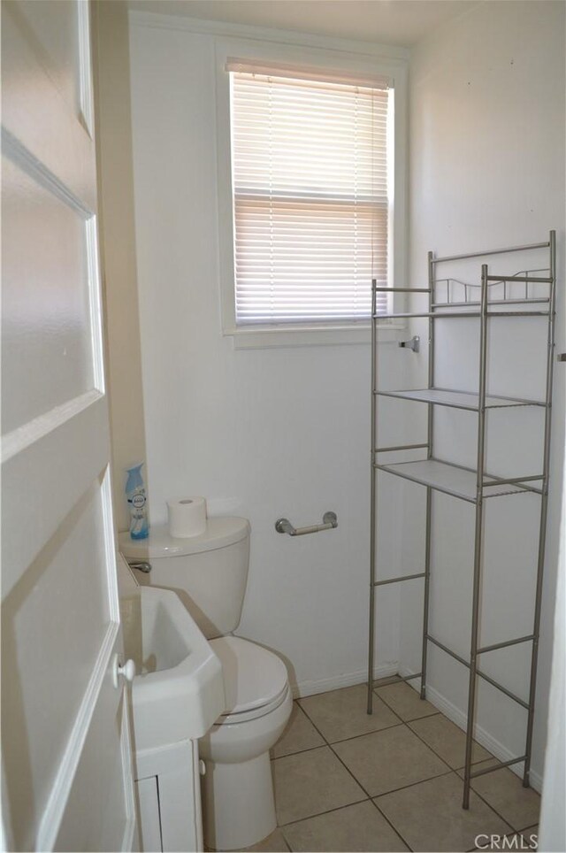 bathroom with tile patterned flooring and toilet