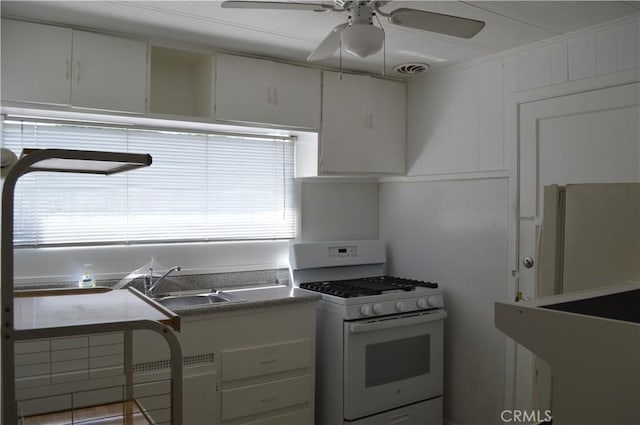 kitchen with white cabinetry, sink, and white appliances