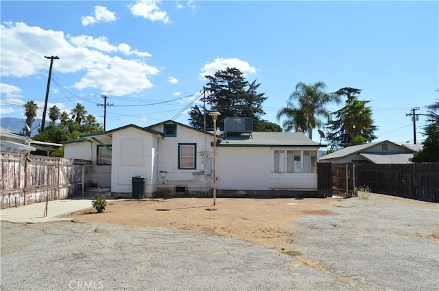 rear view of house featuring central AC unit