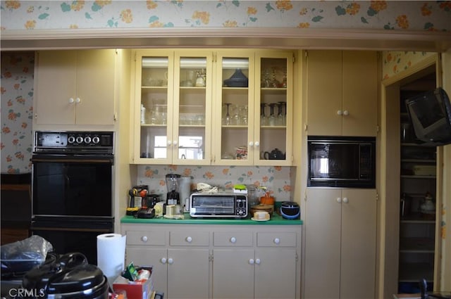 kitchen with white cabinets and black appliances