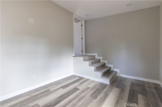 stairway with hardwood / wood-style flooring