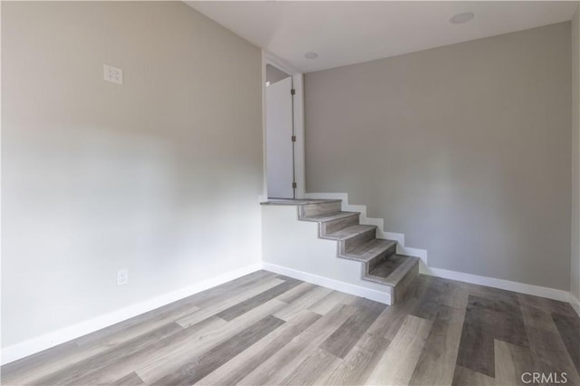 stairs with baseboards and wood finished floors