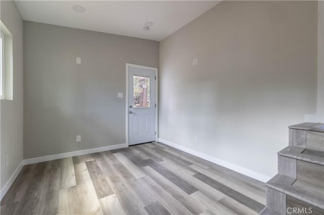 entryway featuring wood finished floors and baseboards