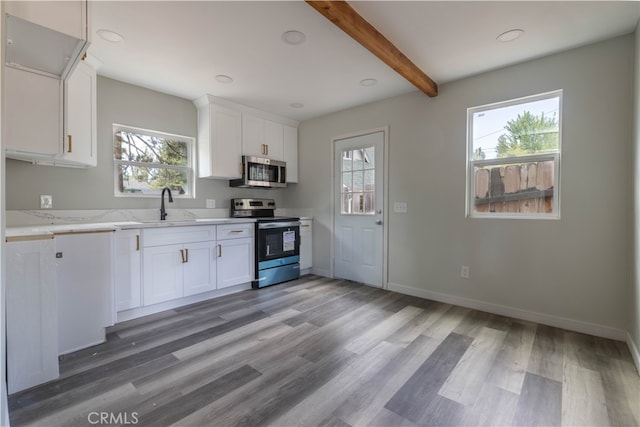 kitchen with white cabinets, stainless steel appliances, and plenty of natural light