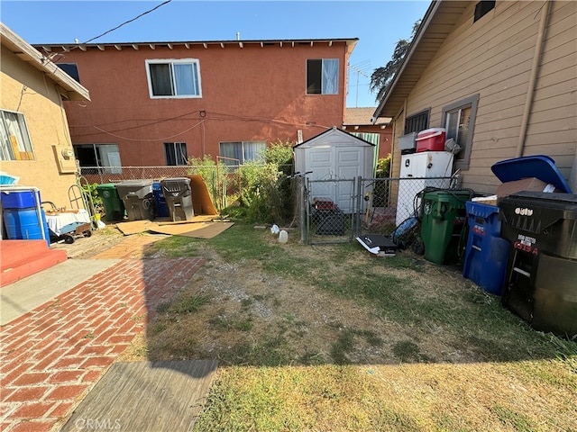 view of yard featuring a storage shed and a patio area