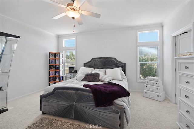 carpeted bedroom with ceiling fan, ornamental molding, and multiple windows