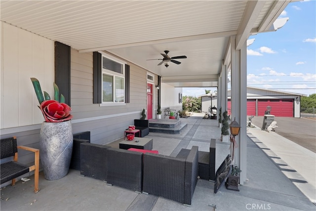 view of patio featuring an outdoor structure, a garage, and ceiling fan