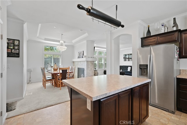 kitchen featuring light carpet, a wealth of natural light, stainless steel refrigerator with ice dispenser, and a center island