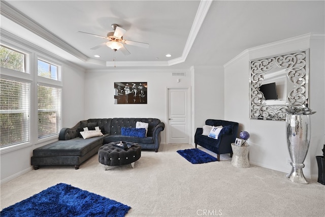 living room featuring carpet floors, ornamental molding, and ceiling fan