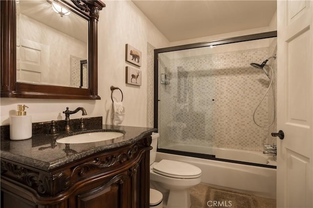 full bathroom with vanity, combined bath / shower with glass door, and toilet