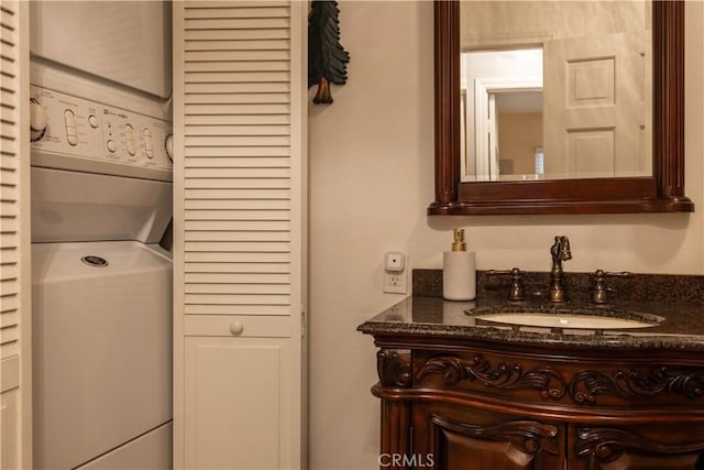 bathroom featuring vanity and stacked washer and dryer