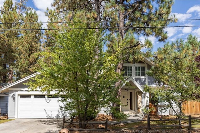 view of property hidden behind natural elements with a garage