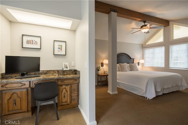 bedroom featuring ceiling fan, built in desk, light carpet, and vaulted ceiling with beams