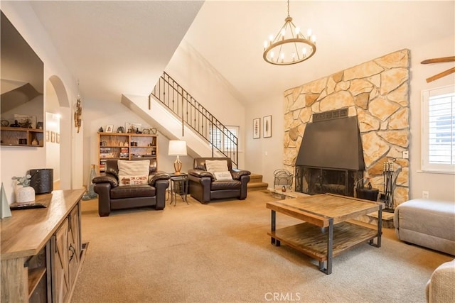 carpeted living room with vaulted ceiling and a chandelier