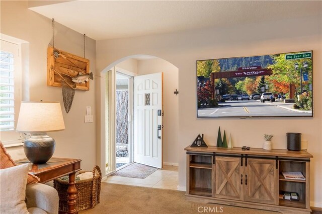 foyer entrance featuring light colored carpet