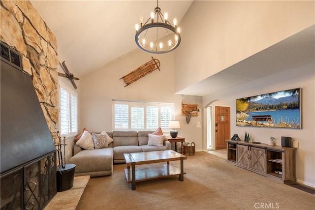 living room with high vaulted ceiling, a chandelier, and carpet flooring