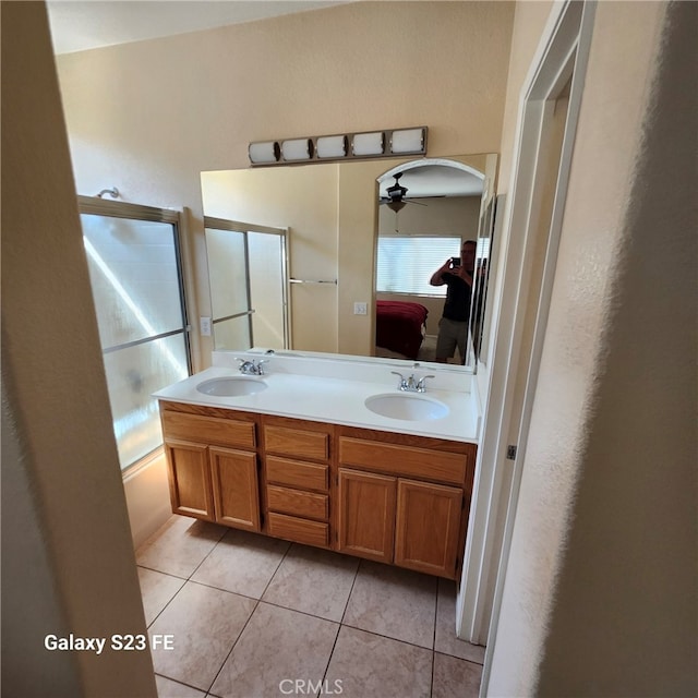 bathroom with ceiling fan, vanity, tile patterned floors, and bath / shower combo with glass door