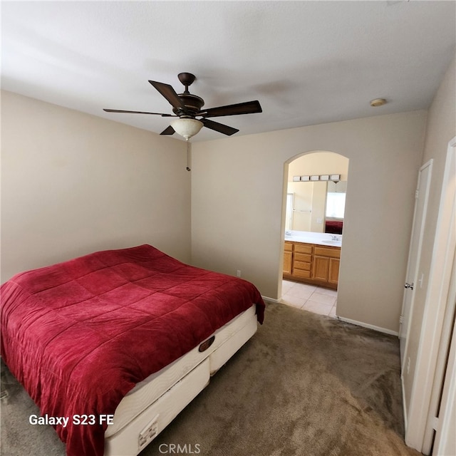 carpeted bedroom with ceiling fan and connected bathroom