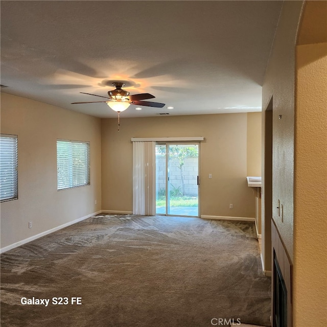 unfurnished room with carpet floors and ceiling fan